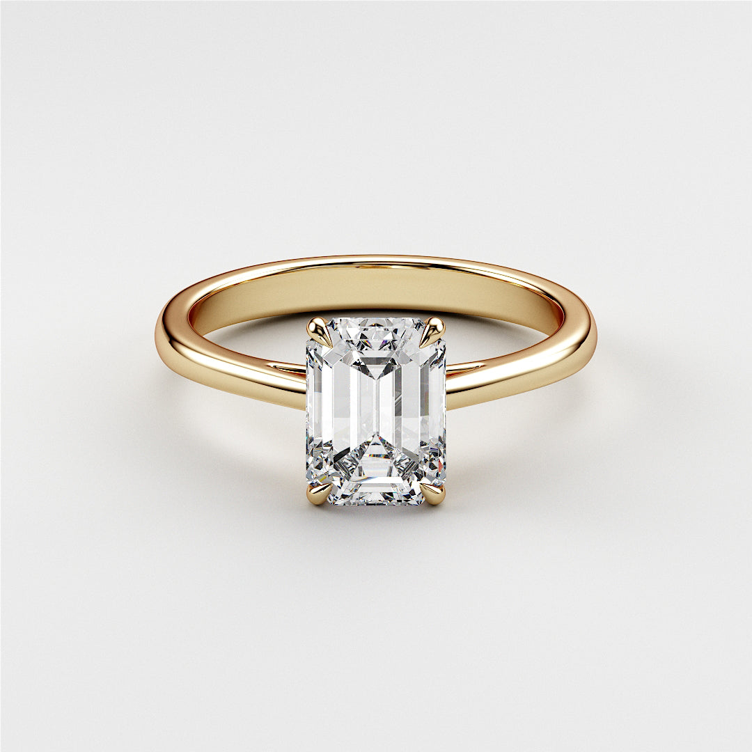 Elegant emerald-cut diamond engagement ring in 14K yellow gold, a timeless piece perfect for proposals and special occasions.