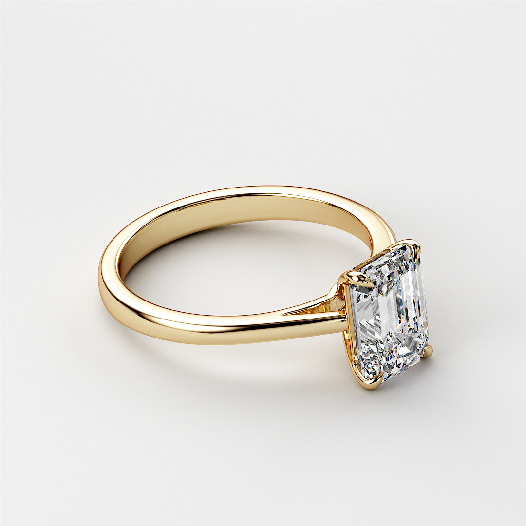Elegant emerald-cut solitaire engagement ring in 14K or 18K yellow gold, highlighting the diamond's timeless beauty and sparkle.