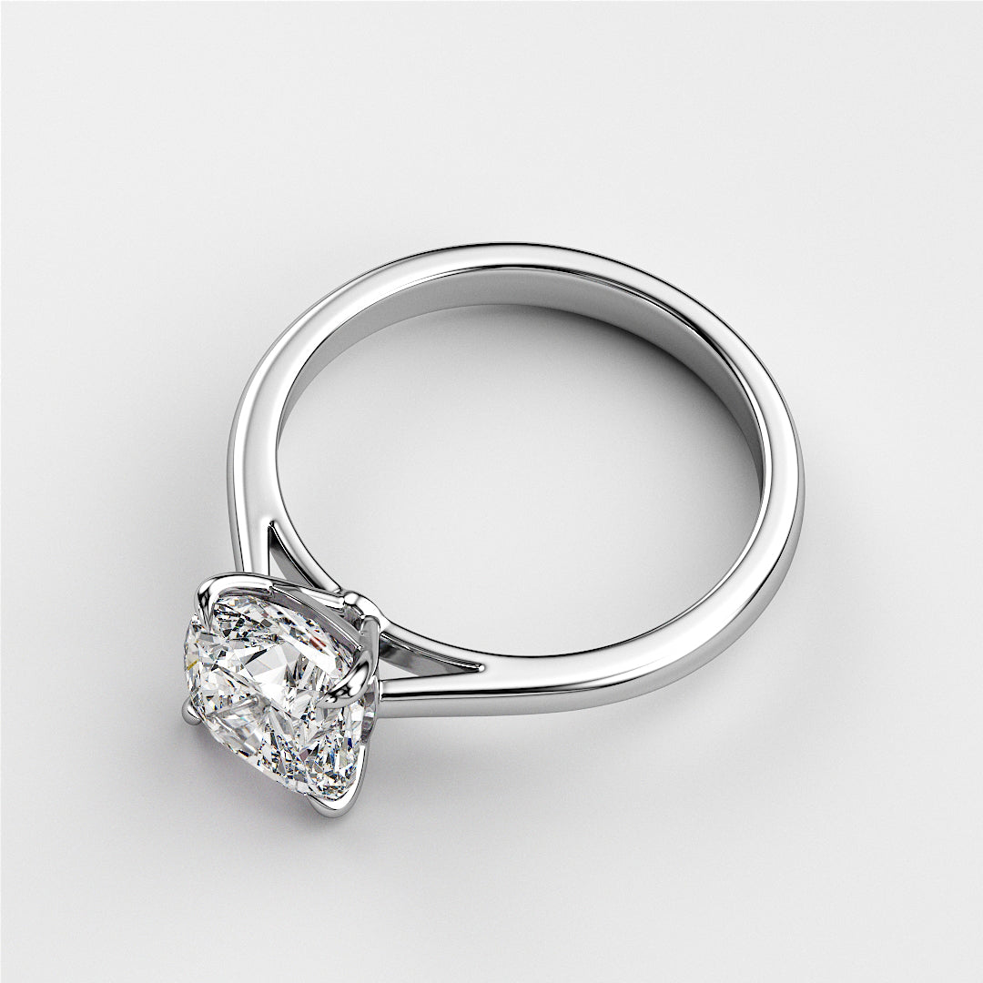 Elegant white gold solitaire engagement ring featuring a cushion-cut diamond, available in 14K or 18K options.