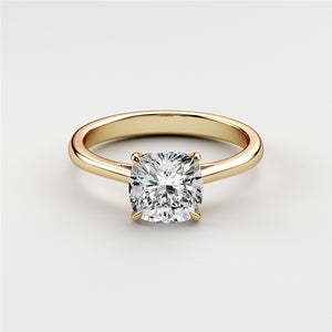 Elegant cushion-cut diamond solitaire engagement ring in 14K yellow gold setting, showcasing timeless beauty. Not worn on model.