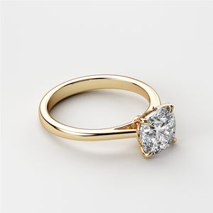 Elegant 14K yellow gold cushion-cut classic solitaire engagement ring featuring a stunning diamond in a cathedral setting.