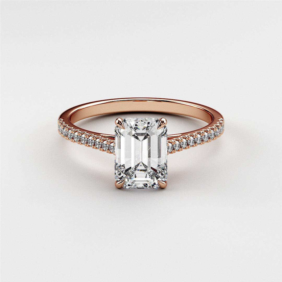 Emerald cut diamond engagement ring in 14K rose gold, featuring a pave band and classic solitaire setting for timeless elegance.