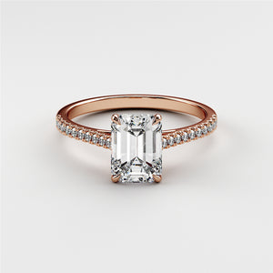 Emerald cut diamond engagement ring in 14K rose gold, featuring a pave band and classic solitaire setting for timeless elegance.