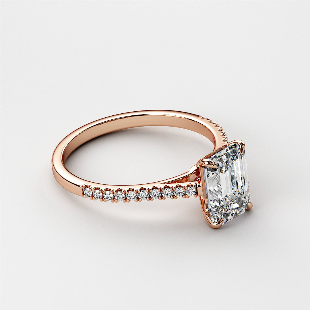 Elegant emerald-cut diamond engagement ring in 14K rose gold, featuring a sparklingPave-set band for a timeless design.