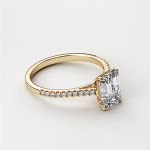 Elegant 14K-yellow gold engagement ring featuring a radiant emerald-cut diamond and accent diamonds for timeless elegance.