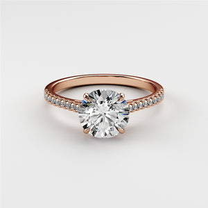 Elegant 14K and 18K rose gold engagement ring featuring a round diamond center stone and diamond-accented band.