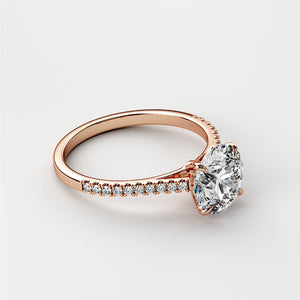 Rose gold engagement ring with a large round-cut diamond and pave band, available in 14K, 18K, or platinum.