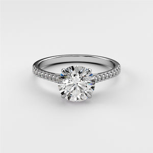 "Elegant 14K or 18K white gold engagement ring with a round diamond and pave accents, showcasing timeless beauty."