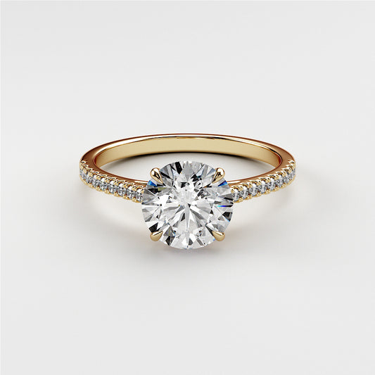 Elegant 14K or 18K gold engagement ring featuring a round-cut diamond and pave accents, ideal for proposals or special occasions.