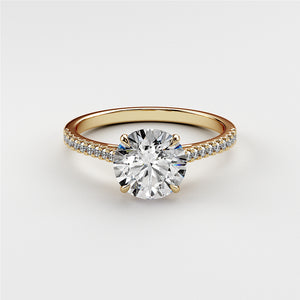 Elegant 14K or 18K gold engagement ring featuring a round-cut diamond and pave accents, ideal for proposals or special occasions.