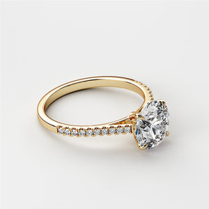 Elegant round diamond engagement ring in 14K or 18K gold or platinum, featuring a sparkling diamond centerpiece andPave-set band.