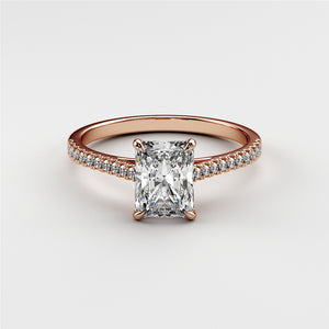 Radiant-cut diamond engagement ring in 14K rose gold, adorned with small diamonds for added brilliance and elegance.