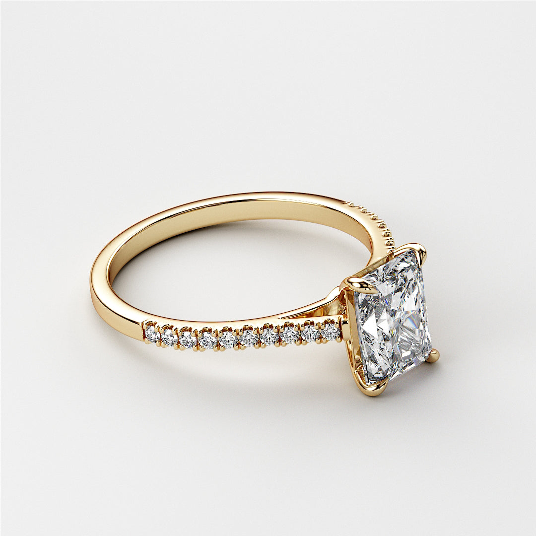 Elegant 14K or 18K gold engagement ring featuring a radiant-cut diamond center stone and side diamonds, showcasing intricate details.|




#14KRecycledYellowGold
#18KRecycledYellowGold





