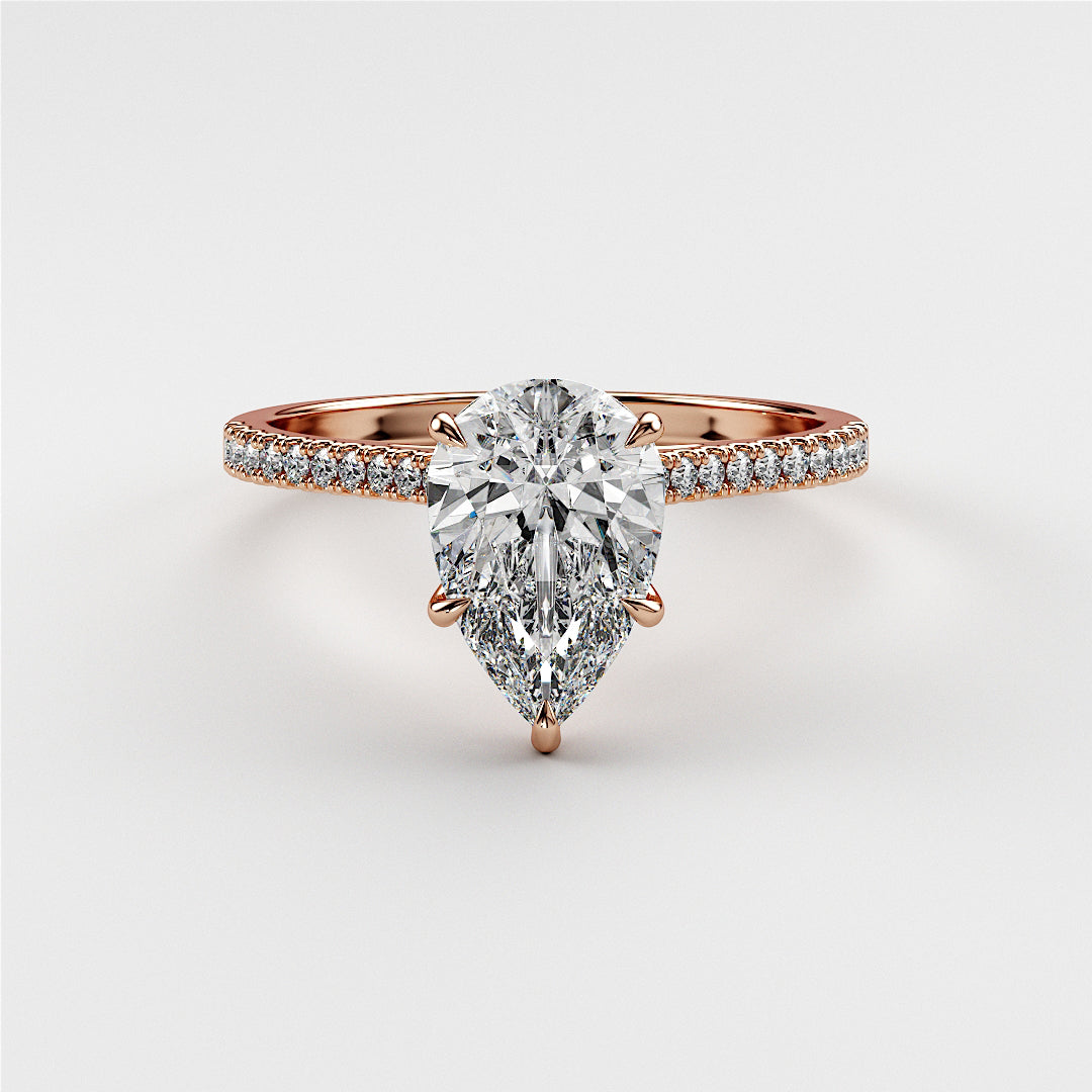 Elegant pear-shaped diamond engagement ring in 14K or 18K rose gold, with a sparklingPave band for ultimate allure.