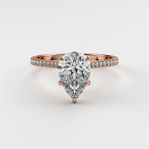 Elegant pear-shaped diamond engagement ring in 14K or 18K rose gold, with a sparklingPave band for ultimate allure.