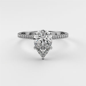 Elegant pear-shaped diamond solitaire engagement ring in 14K or 18K white gold, accented with pave diamonds in a cathedral setting.