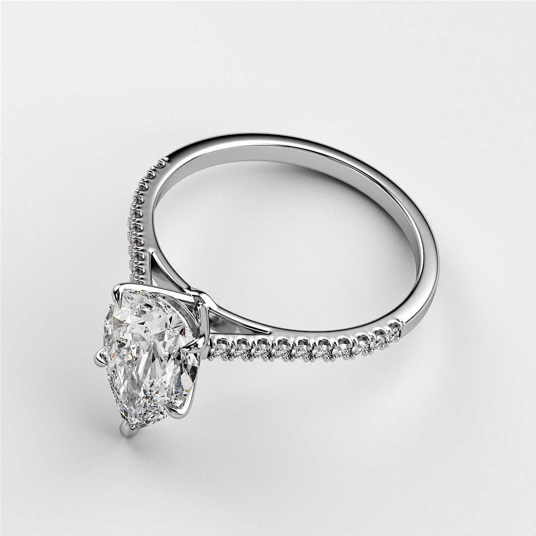 Elegant pear-shaped diamond engagement ring withPave band in 14K, 18K white gold, or platinum. Not worn on a model.
