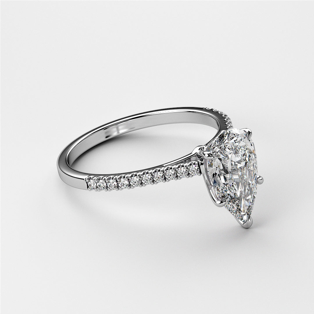 Elegant engagement ring with a pear-shaped diamond in 14K or 18K gold, or platinum, featuring a sparkling diamond band, modeled elegantly.