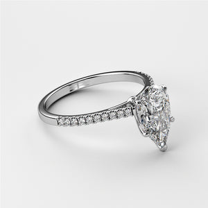 Elegant engagement ring with a pear-shaped diamond in 14K or 18K gold, or platinum, featuring a sparkling diamond band, modeled elegantly.