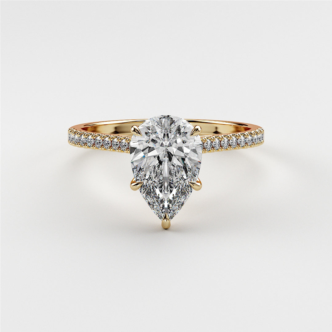 Pear-shaped diamond engagement ring withPave band in 14K or 18K gold or platinum on white background.