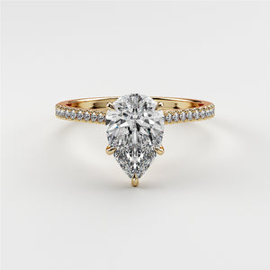 Pear-shaped diamond engagement ring withPave band in 14K or 18K gold or platinum on white background.