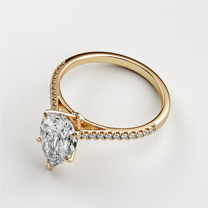 "Luxurious 14K or 18K gold pear solitairePave cathedral engagement ring featuring a stunning diamond on a clean background."