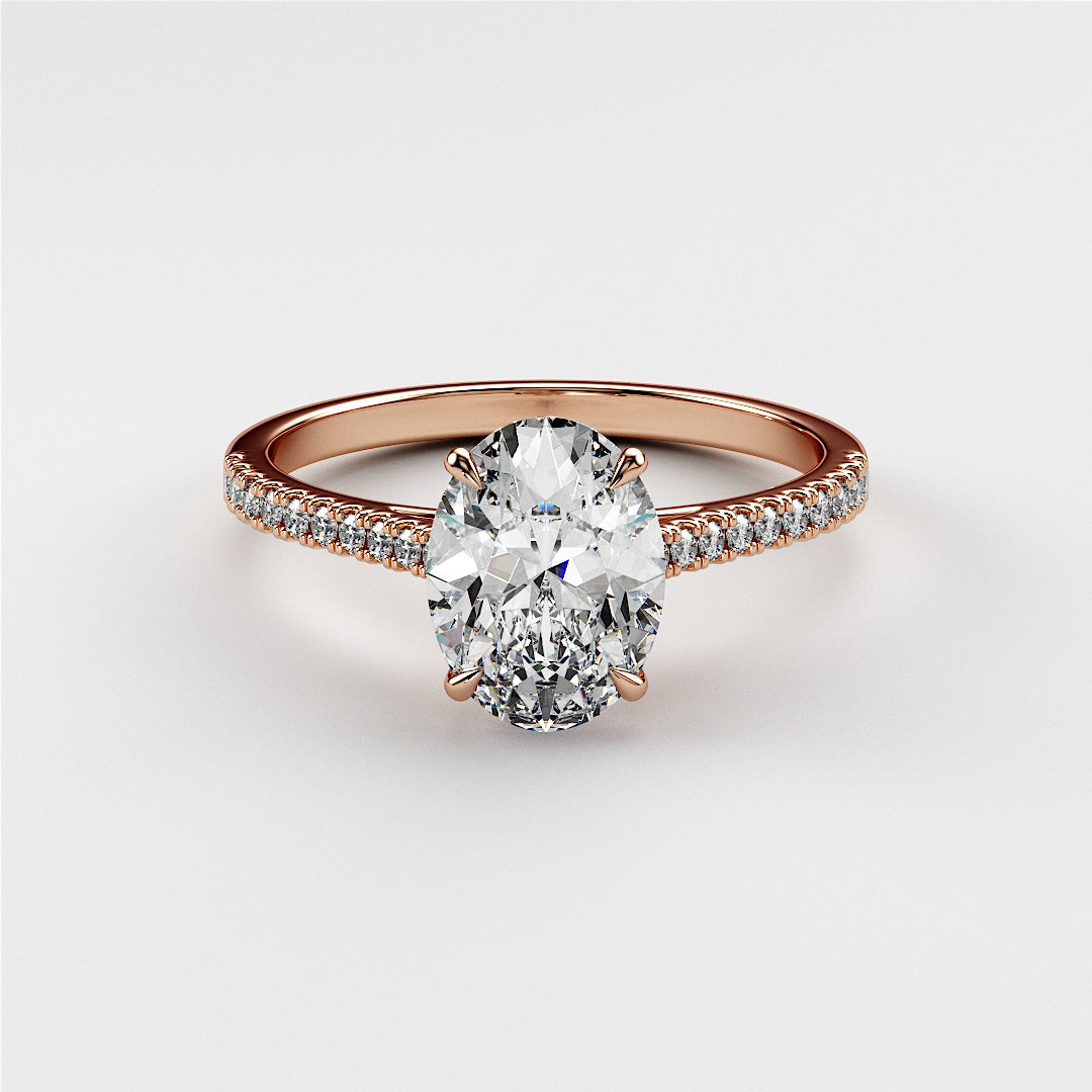 Elegant oval diamond engagement ring with pave band in rose gold. Available in 14K, 18K, or platinum for your special moments.