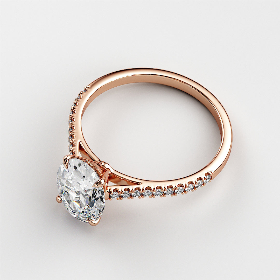 Elegant 14K or 18K rose gold engagement ring featuring a marquise-cut diamond and a delicate band with smaller diamonds.