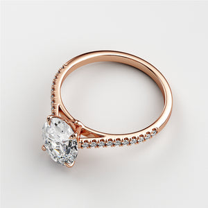 Elegant 14K or 18K rose gold engagement ring featuring a marquise-cut diamond and a delicate band with smaller diamonds.