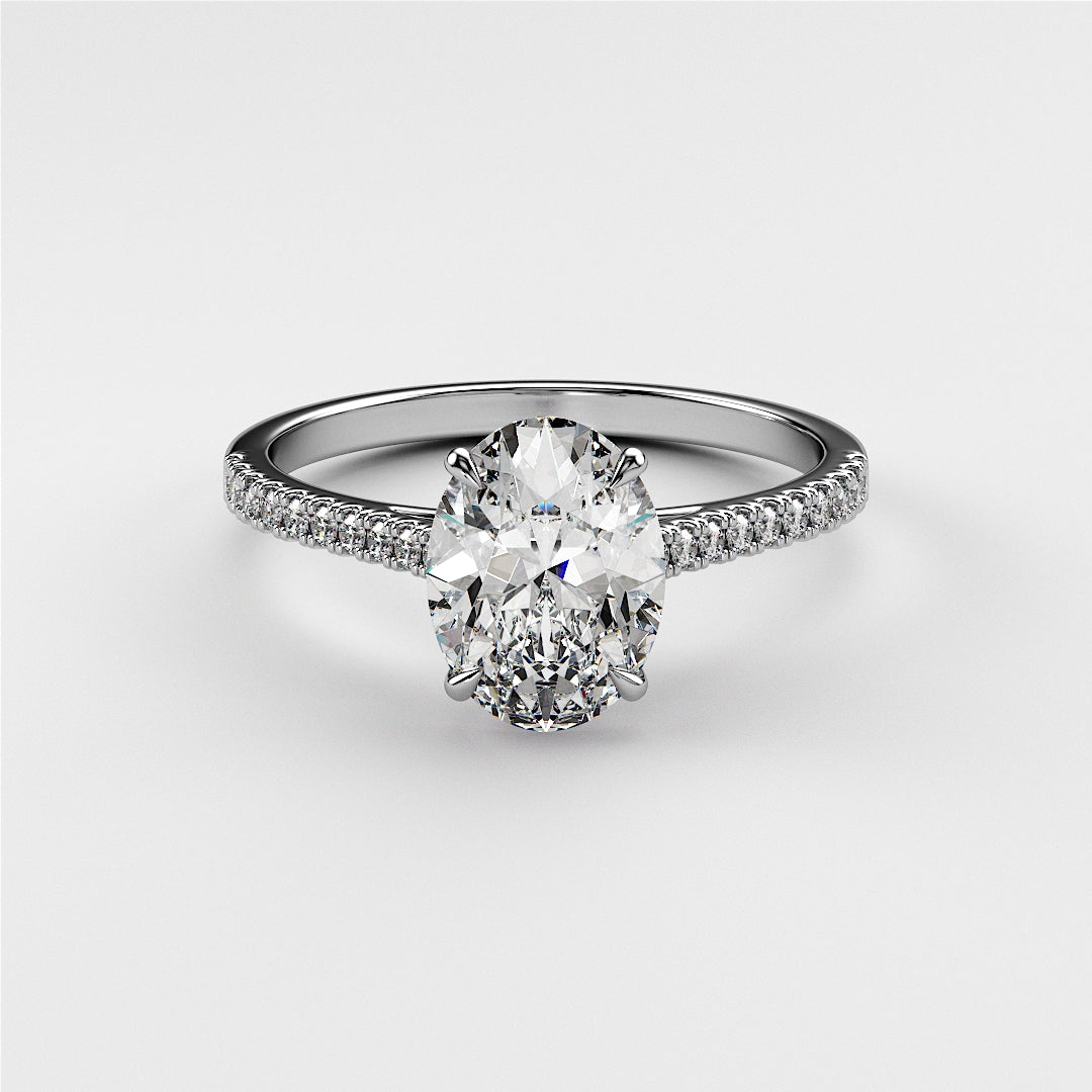 Elegant 14K white gold engagement ring featuring a stunning oval diamond center stone and delicate pave diamond band.