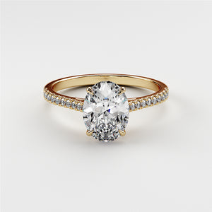 14K or 18K gold engagement ring featuring an elegant oval diamond center stone and a delicate pave band.
