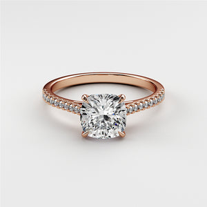 Elegant rose gold cushion-cut diamond engagement ring withPave band, available in 14K, 18K, and platinum. Unworn on white background.