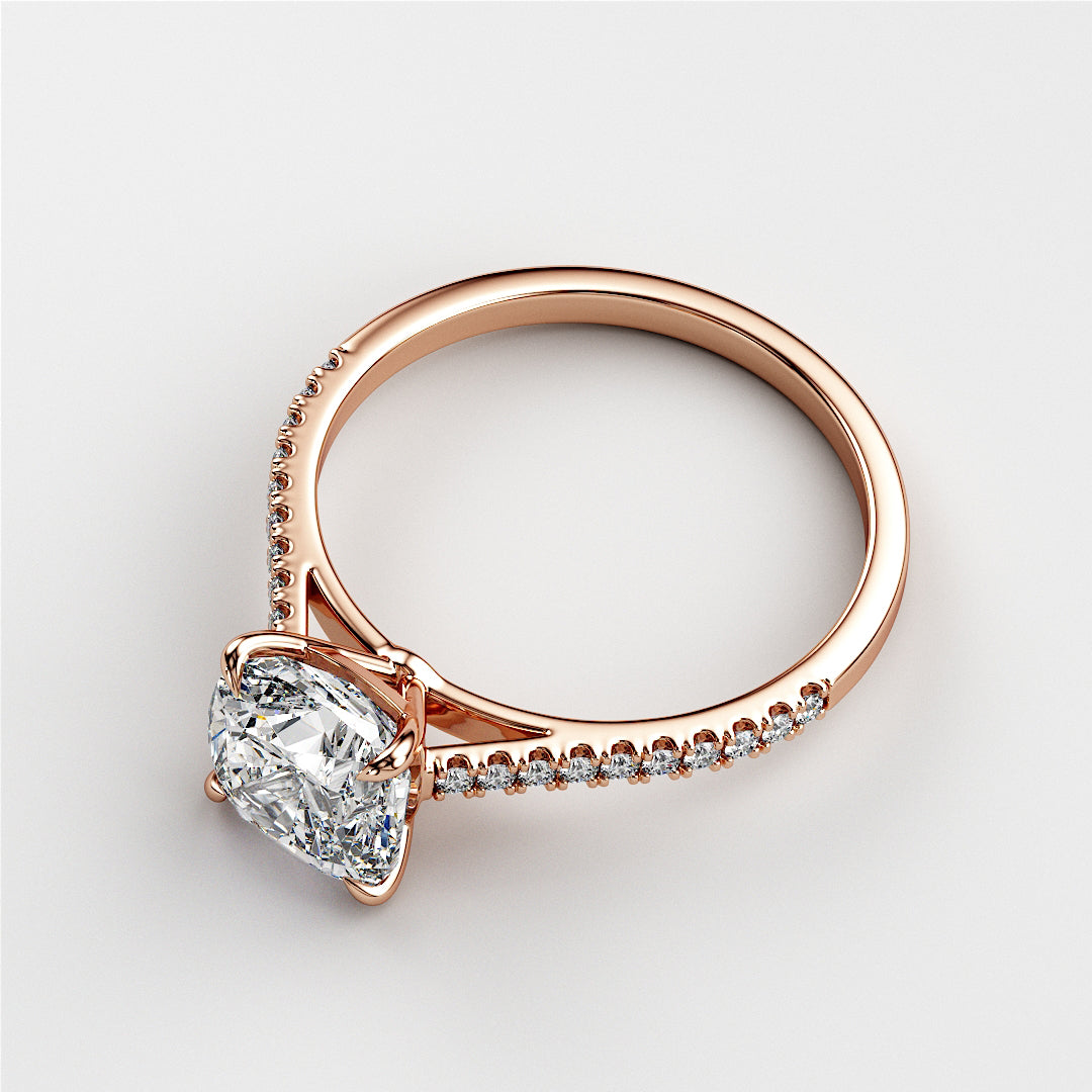 Elegant 14K rose gold engagement ring with cushion cut diamond and halo of accent diamonds, radiating timeless beauty.
