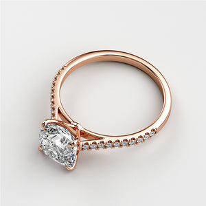 Elegant 14K rose gold engagement ring with cushion cut diamond and halo of accent diamonds, radiating timeless beauty.
