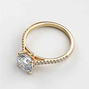 Elegant 14K or 18K gold cushion-cut diamond engagement ring with a pave cathedral band, perfect for a timeless proposal.