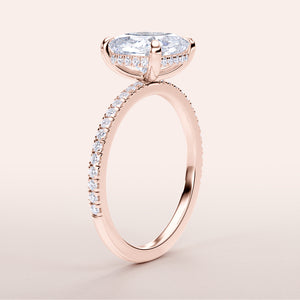 Elegant oval diamond engagement ring with pave band in 14K or 18K rose gold or platinum, showcasing hidden halo design.