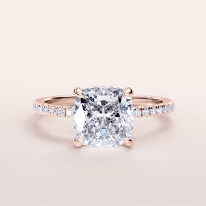 Elegant cushion-cut diamond engagement ring in 14K rose gold, featuring a pave band with dazzling diamonds.