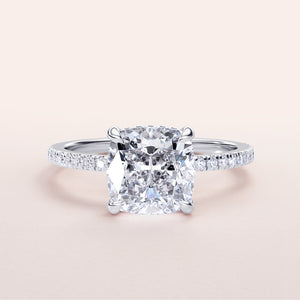 Cushion-cut diamond engagement ring with pave band in 14K or 18K white gold, perfect for a timeless proposal.