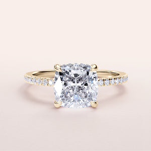 Elegant 14K gold cushion-cut diamond ring with a diamond-studded band on a neutral background. Perfect for engagement.