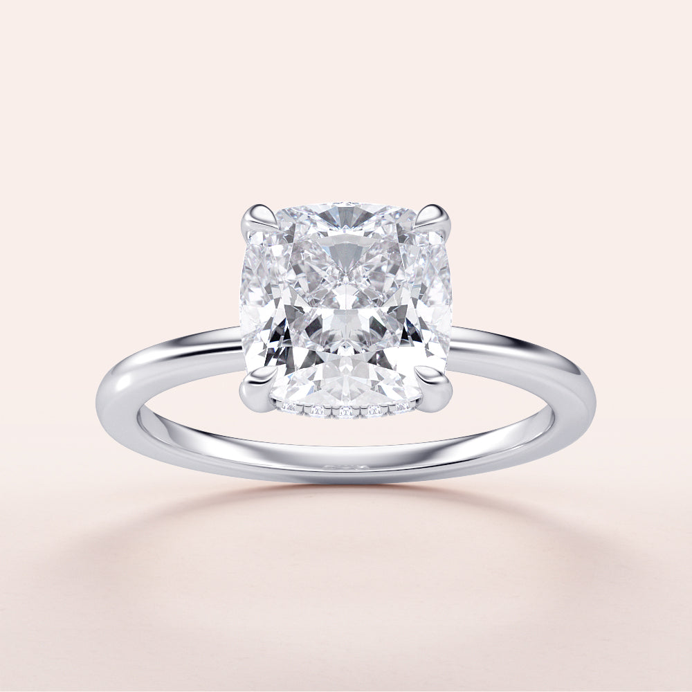 Cushion-cut diamond engagement ring in 14K or 18K white gold, featuring a hidden halo and plain band design.|

#14KRecycledWhiteGold
#18KRecycledWhiteGold








#Platinum
