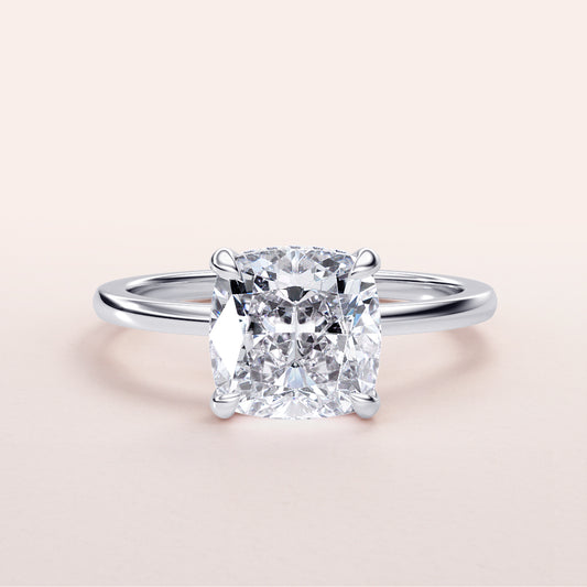 Radiant cushion-cut diamond engagement ring in a sleek 14K or 18K gold band, elegant hidden halo design for a stunning look.