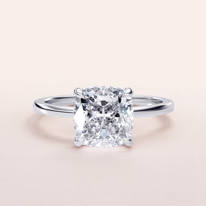 Radiant cushion-cut diamond engagement ring in a sleek 14K or 18K gold band, elegant hidden halo design for a stunning look.