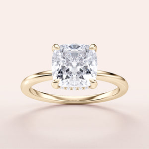 "Elegant yellow gold engagement ring featuring a cushion-cut diamond in a hidden halo design. Timeless luxury, perfect for proposals."