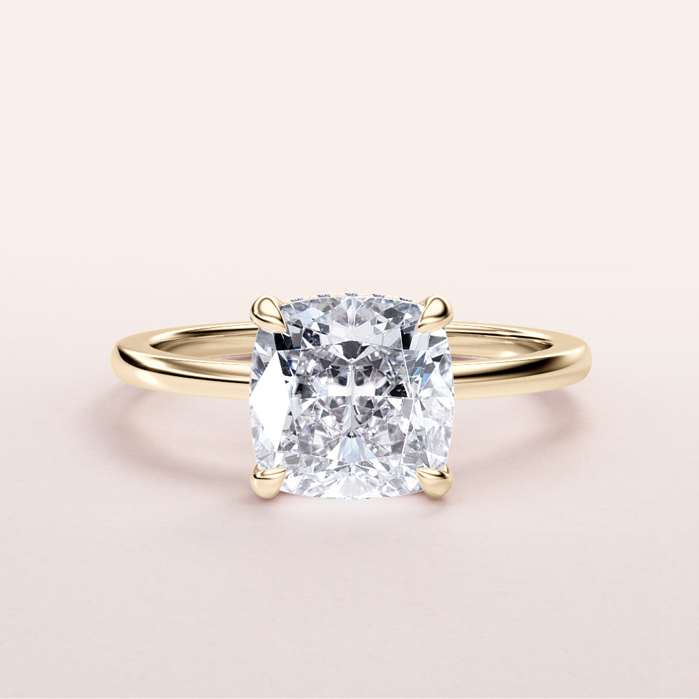 Elegant cushion-cut diamond engagement ring in a sleek 14K gold band, displayed on a neutral background.|




#14KRecycledYellowGold
#18KRecycledYellowGold





