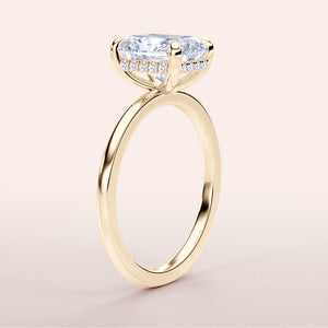Elegant 14K yellow gold engagement ring with a radiant diamond center stone and delicate halo of smaller diamonds.