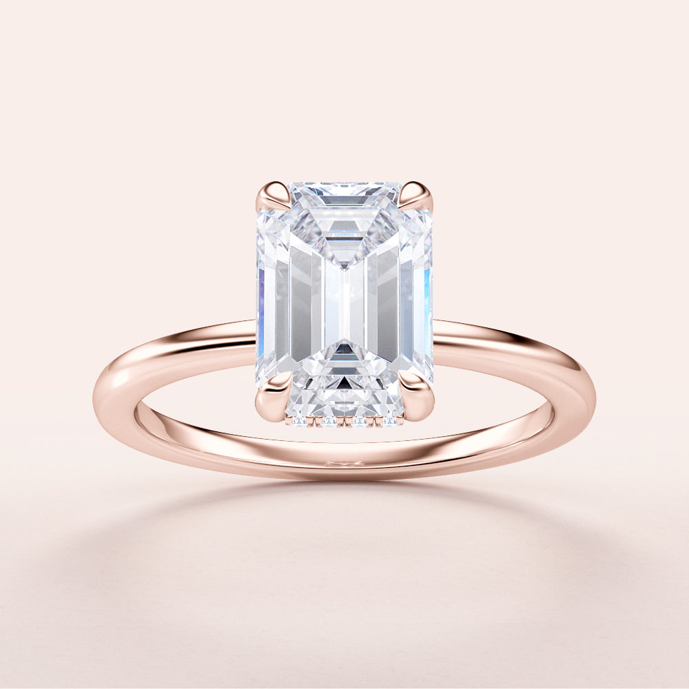 Elegant emerald-cut diamond engagement ring with hidden halo in rose gold, available in 14K, 18K, or platinum.