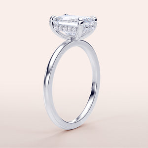 Elegant white gold engagement ring with emerald-cut diamond and hidden halo, available in 14K or 18K options. 