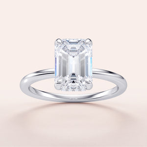 Elegant 14K/18K white gold engagement ring featuring emerald-cut diamond and hidden halo, perfect for special occasions.