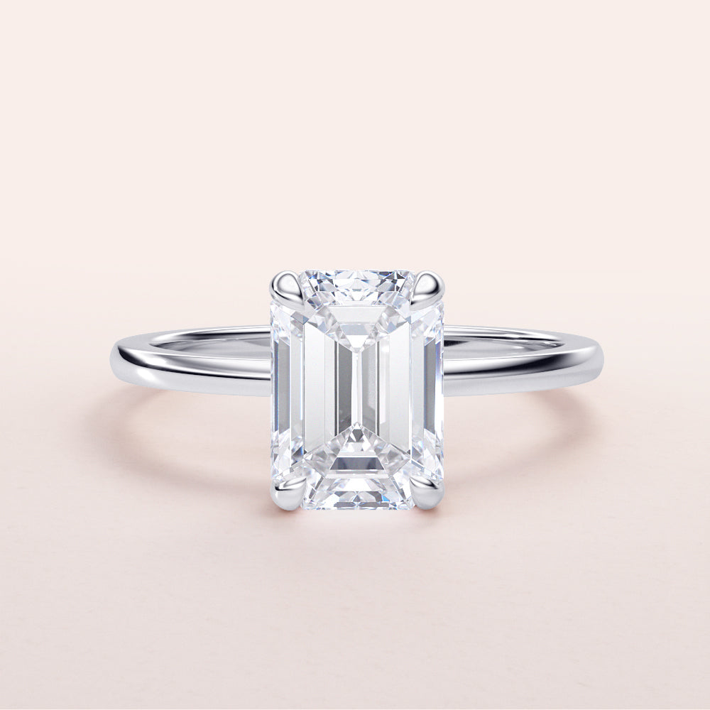 Elegant 14K white gold engagement ring with a radiant emerald-cut diamond in a hidden halo design for a timeless look.