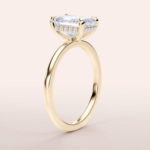 Elegant 14K yellow gold emerald hidden halo engagement ring with a classic plain band, not worn on model.